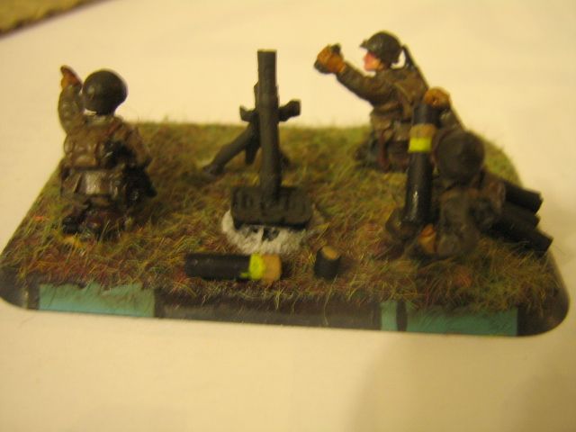 typical 81mm base showing conversion of figure to look like hes pulling the cap off a ammo cylinder